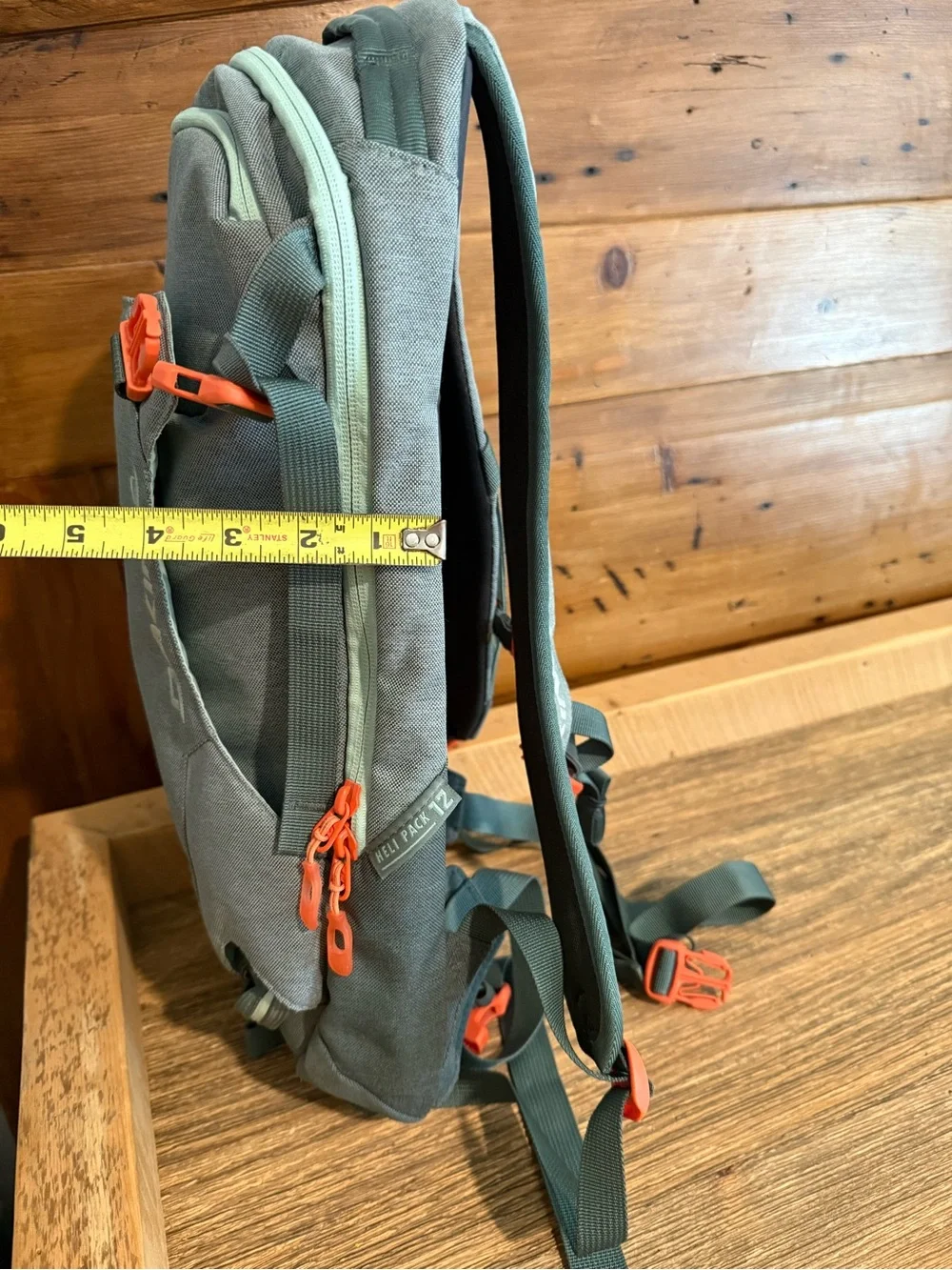 Dakine Mint tinted heli pack 12 backpack with Orange Buckles